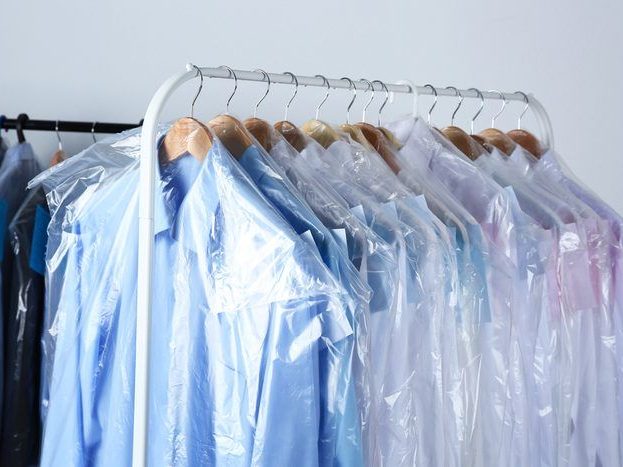 Dry-cleaned, pressed shirts on hangers with plastic covers