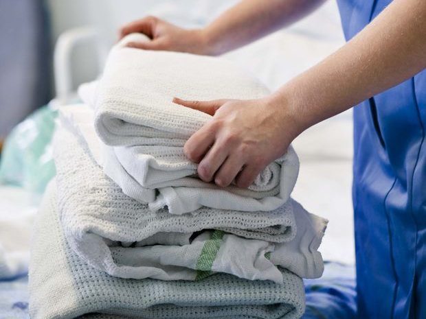 Person folding clean towels: wash and fold in Río Grande, Puerto Rico